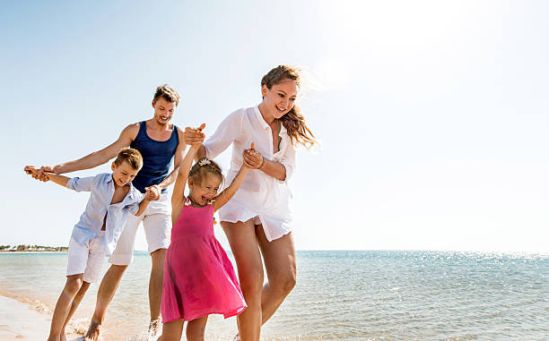 istock Playful young family on the beach. 533741125