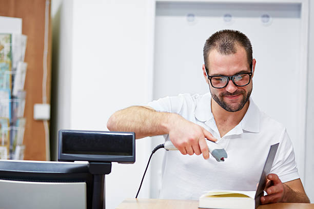 istock Salesman at the checkout in a bookstore 533741655