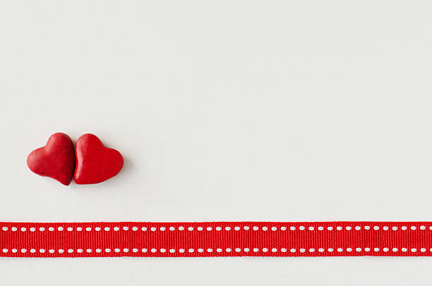 istock Two red hearts and red ribbon 533742127