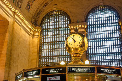 New York, NY, USA - December 28, 2014: Famous Clock on the top of the information booth in the main Concourse of Grand Central Terminal. GCT is a commuter railroad terminal in Midtown Manhattan with 44 platforms serving 67 tracks along them. It is the largest train station in the world by the number of platforms.