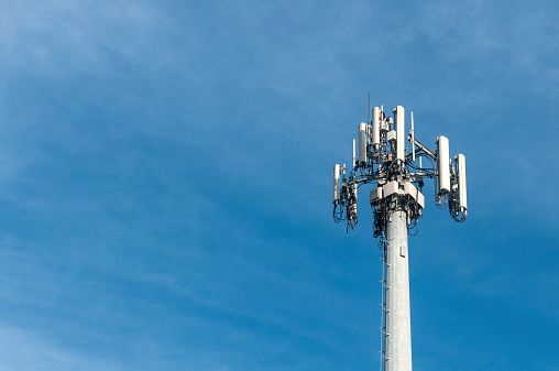 Signal tower or Mobile phone tower .Global connection and internet network concept.on blue sky.