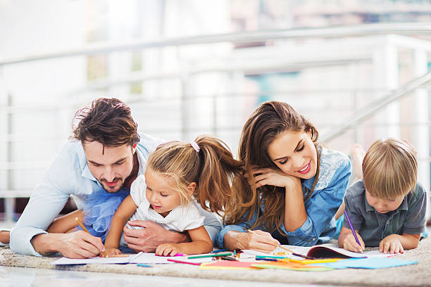 istock Young parents coloring with their little children. 533746029