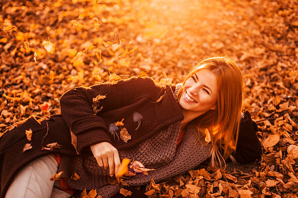 istock Smiling woman on autumn leaves. 533746311