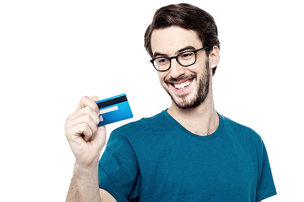 istock Young man holding credit card 533746339