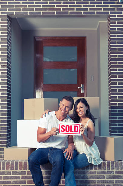 istock Happy couple outside a house with moving boxes. 533747391