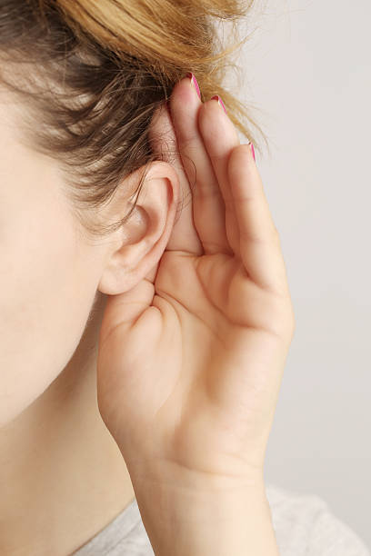 聞く gossiping - listening human ear communication human hand ストックフォトと画像