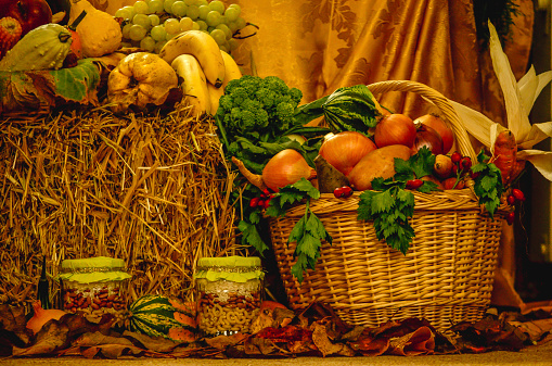 A basket full of vegetables and other products for Thanksgiving holiday