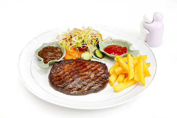 istock Beefsteak served with fries and salad 533777187