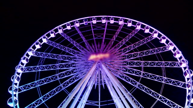 Ferris wheel spinning by night