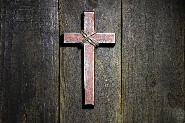 istock Wooden cross hanging on rustic wood wall 533831427