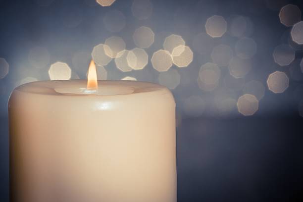 istock close-up of candle with flame on wood table 533831618