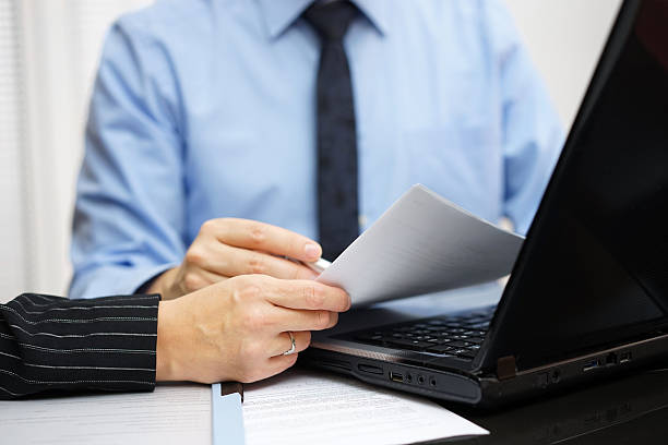 istock Consultant and client are working with documents and laptop 533831905