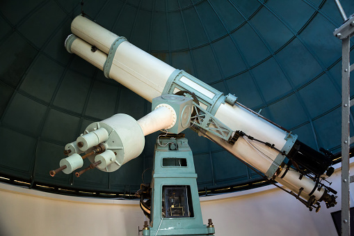 closeup view on oculars of large professional telescope located indoors