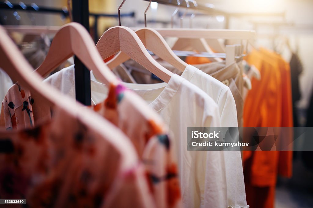 Ropa en la percha en la boutique de la tienda moderna - Foto de stock de Vestimenta libre de derechos