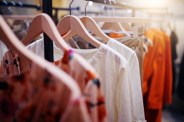 clothing on hanger at the modern shop boutique - moda imagens e fotografias de stock