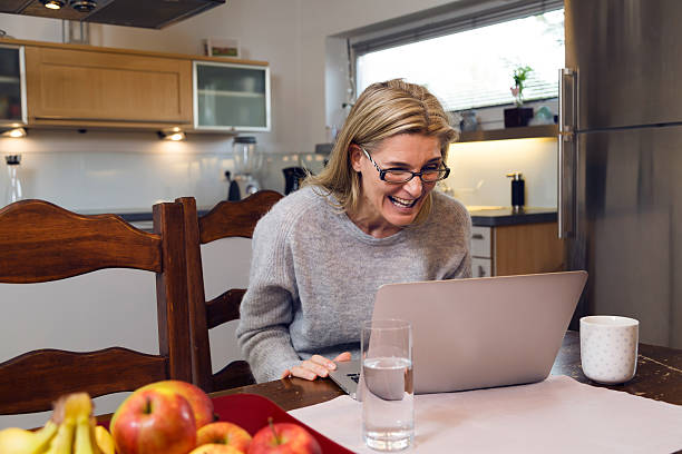 istock Excited woman peering closely at her laptop 533835006