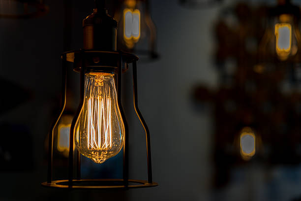 istock Edison bulb glowing in the dark blurred background 533835208