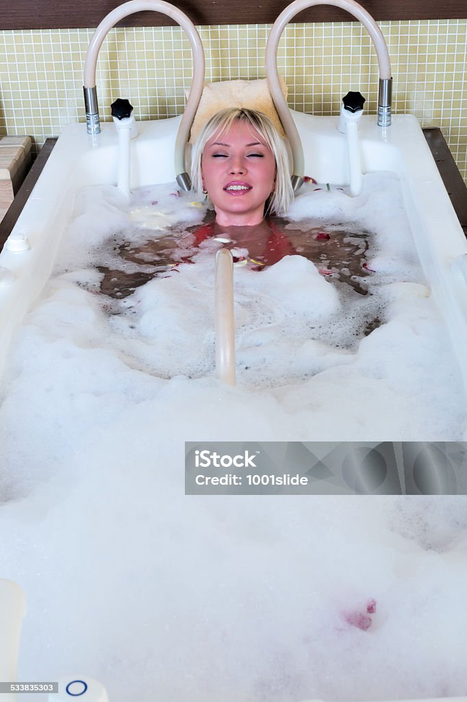 Spa Beautiful woman happy in spa - red skin by reason of hot water with soap 2015 Stock Photo