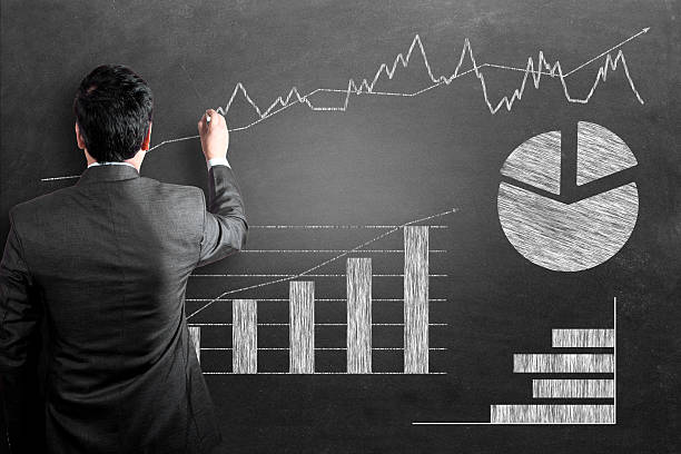 istock Businessman analyzing business graph on chalkboard 533835803