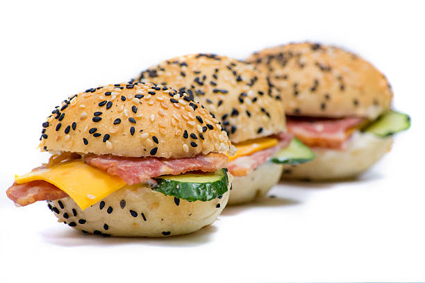 istock hamburgers with vegetables and bacon on a white background 533835996