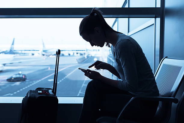 istock Woman using internet in the airport terminal 533836761