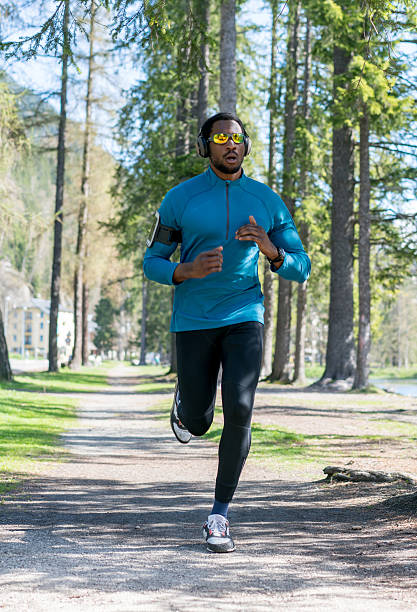 istock Man running outdoors listening to music 533837594