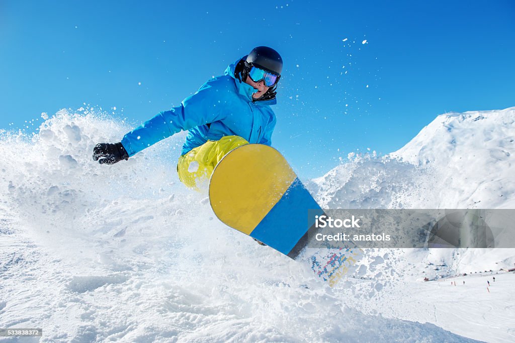 Active snowboarder jumping Active snowboarder jumping in winter mountains Snowboarding Stock Photo