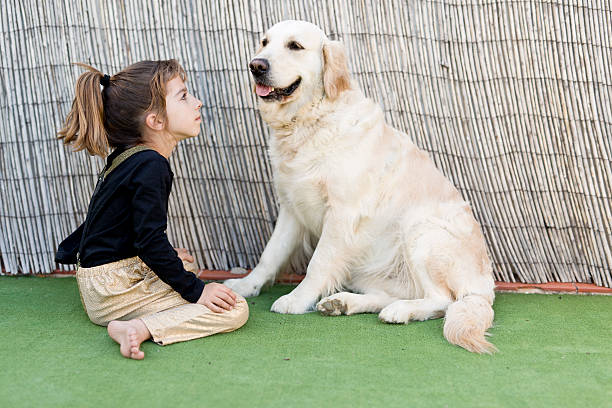 istock Little girl with her dog 533839230