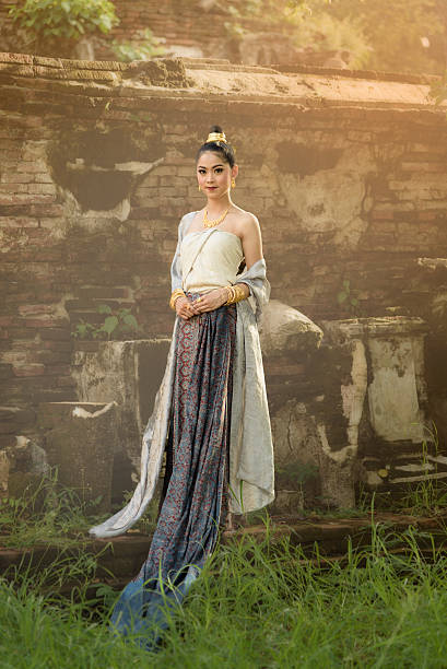 Beautiful Thai girl in Thai traditional costume Beautiful Thai girl in Thai traditional costume with old temple background thai traditional costume stock pictures, royalty-free photos & images