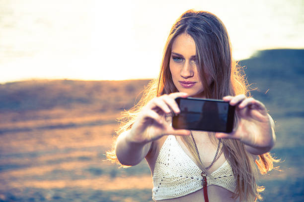 istock Girl with smart phone near beach 533840292