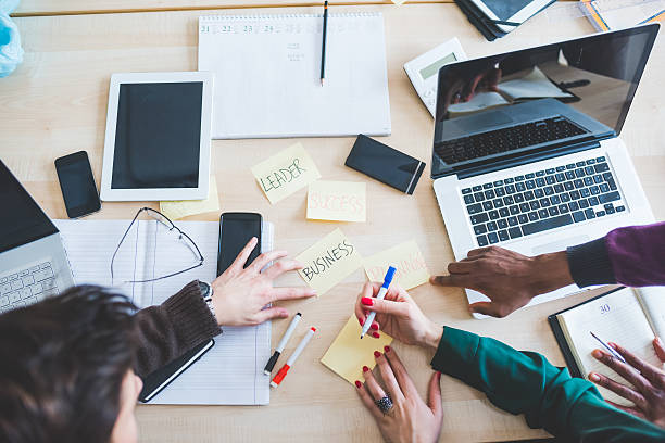 istock Top view of an office desk with people working 533840674
