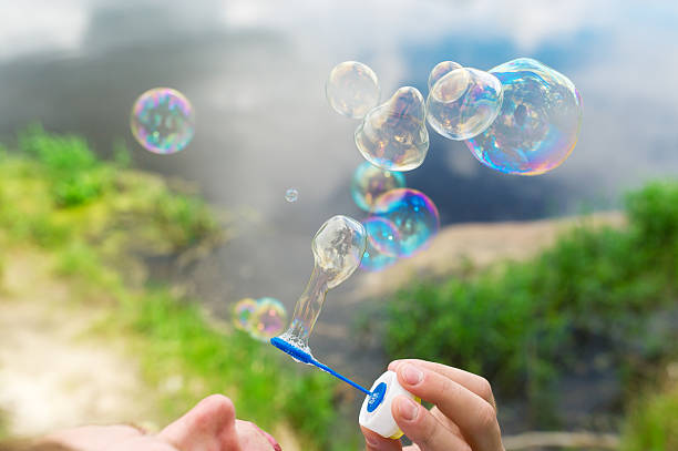 istock Soap bubbles fly against a beautiful landscape. 533842078