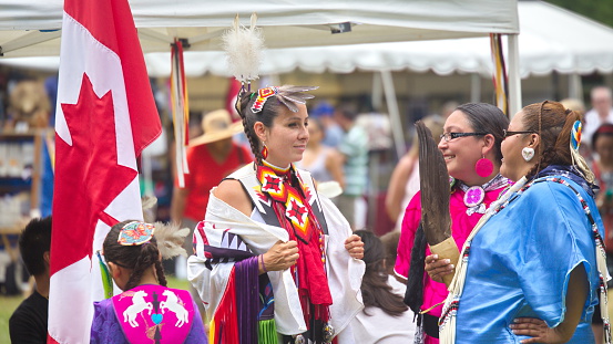 Fort York, Toronto - July 25, 2015 - Native American performers dancing at a pow-wow dressed in their traditional costumes representing their tribes.