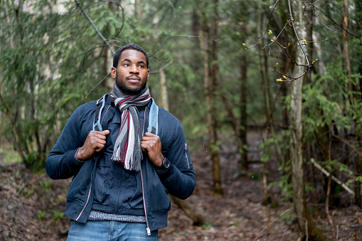 Handsome African American man hiking in the mountains