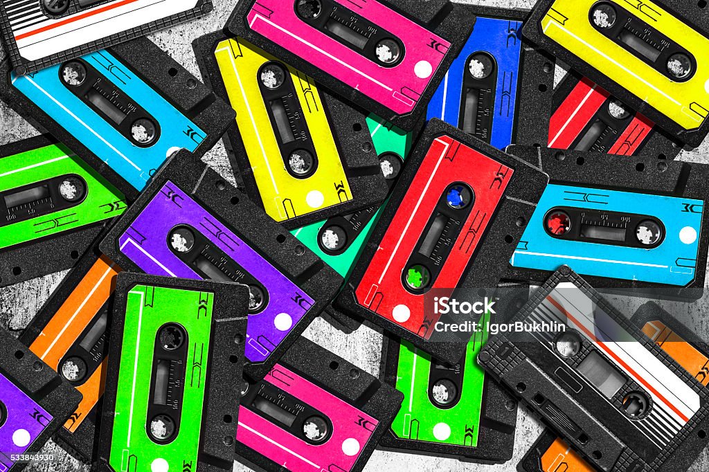Old audio cassette. Multicolored audio tapes. Close-up view. Old audio cassette. Multicolored audio tapes. Close-up view. The concept of old music. The era of retro songs. Isolated objects. large collection of retro cassette tapes. The music of yesteryear. 1980-1989 Stock Photo