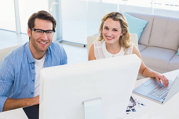 istock Cheerful photo editors working together on graphics tablet 533846495