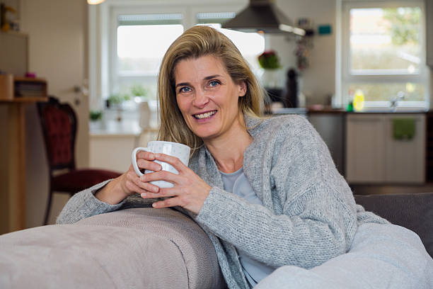 istock Attractive blonde woman drinking coffe at home 533846540