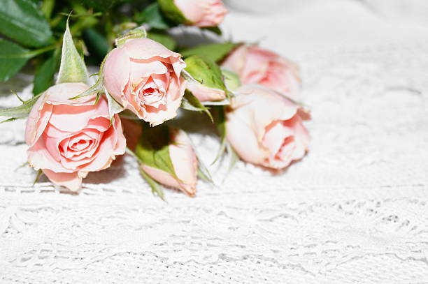 Bouquet of pink roses and white lace
