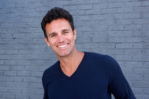 istock Close up handsome guy smiling against gray wall 533850134