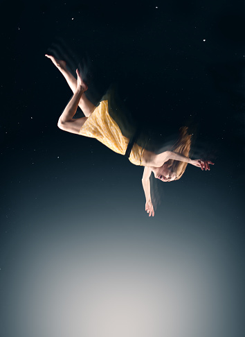 A conceptual image of a woman falling in a dream.