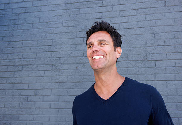 istock Handsome mature man smiling against gray wall 533850786
