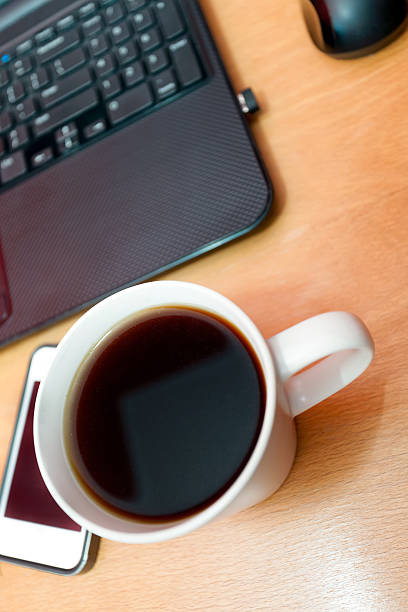 istock Authentic morning coffee laptop phone wooden table. 533852352
