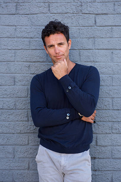 istock Pensive man standing with hand on chin 533853690