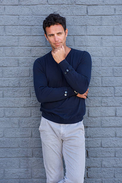 istock Older man glance with hand on chin 533854298