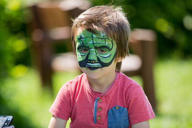 istock Cute little five years old boy, having his face painted 533854566