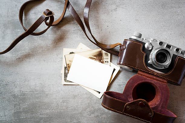 Vintage photos and old camera Old vintage photos and old camera on concrete background old black leather photo album stock pictures, royalty-free photos & images