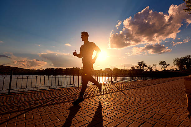 istock Running man silhouette in sunset time. 533858206