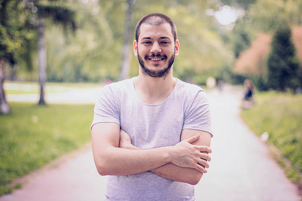 istock Man with crossed arms looking at camera at the park 533858720