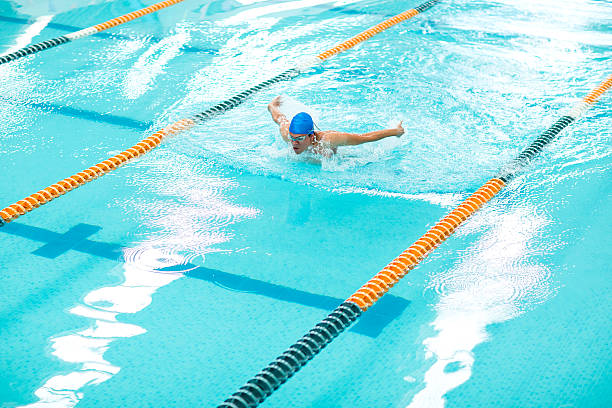 istock Young athletic man with butterfly swimming technique. 533859816