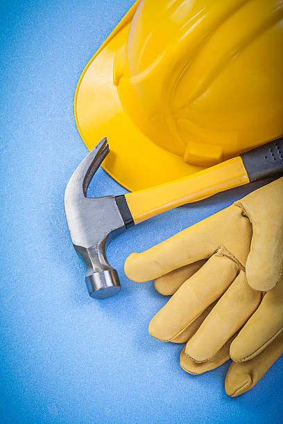istock Claw hammer safety gloves hard hat on blue background vertical 533860146